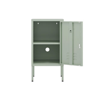 The Camden metal bedside table storage locker in sage green, with the door open
