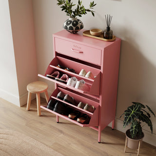 The Shoreditch shoe cabinet in flamingo with a top drawer, two lower shoe compartments and matching handles, styled in a hallway.