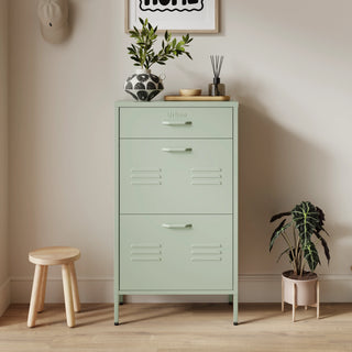 The Shoreditch shoe cabinet in sage with a top drawer, two lower shoe compartments and matching handles, styled in a hallway.